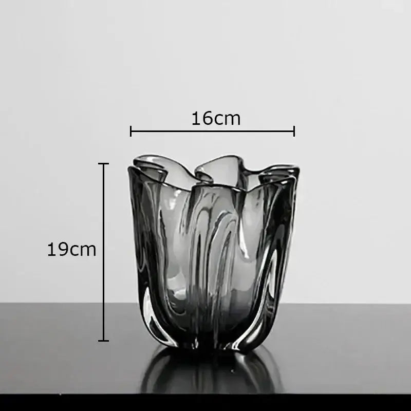 A sleek dark gray decorbites glass vase with fluted rim and smooth curves for hydroponics desk decoration