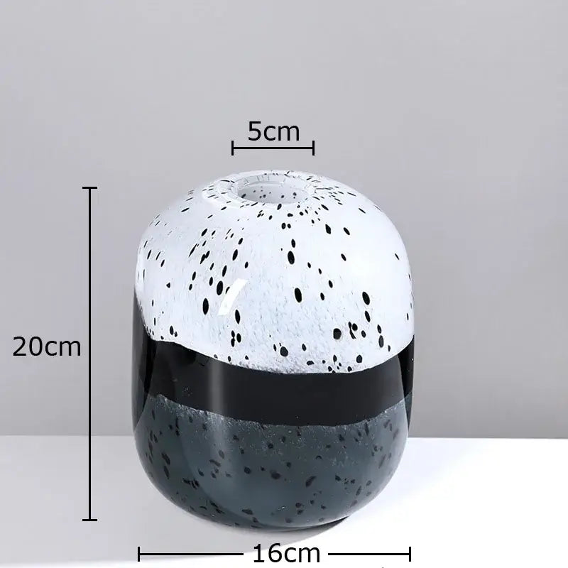 A decorbites glass vase hydroponics flower pot with speckled white black upper half and glossy black gray base