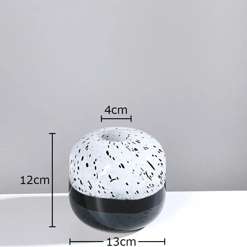 A sleek decorbites glass vase with glossy white speckled upper half and solid black base for vase hydroponics flower use