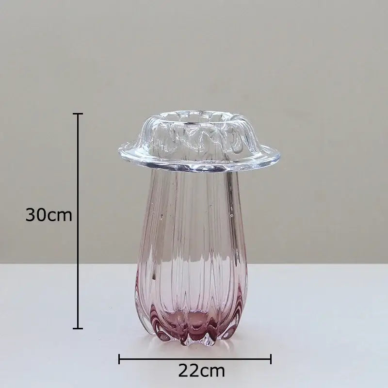 A translucent pink decorbites glass vase with vertical ridges and scalloped rim for hydroponics table decor