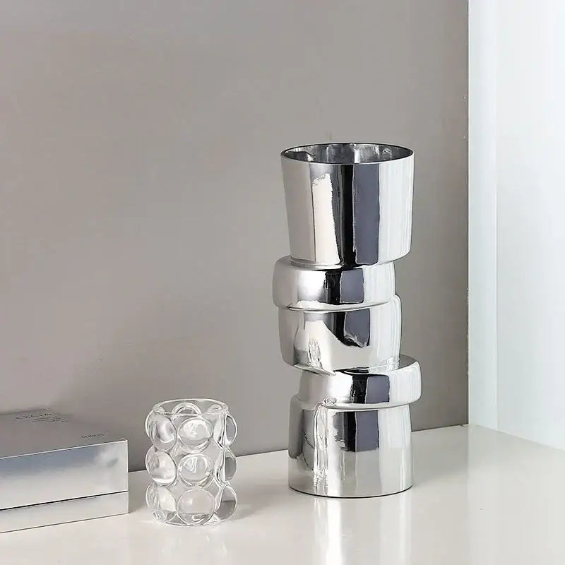 Stack of four sleek silver decorbites glass vases with twist shape for hydroponics and terrarium decoration accessories