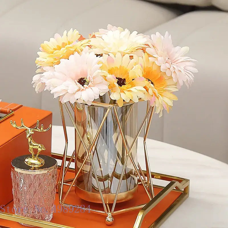 Gold geometric decorbites glass vase metal frame holding artificial yellow and pink daisies for wedding decor