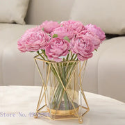 A decorbites glass vase with pink artificial peonies encased in a gold metal frame geometric flower arrangement