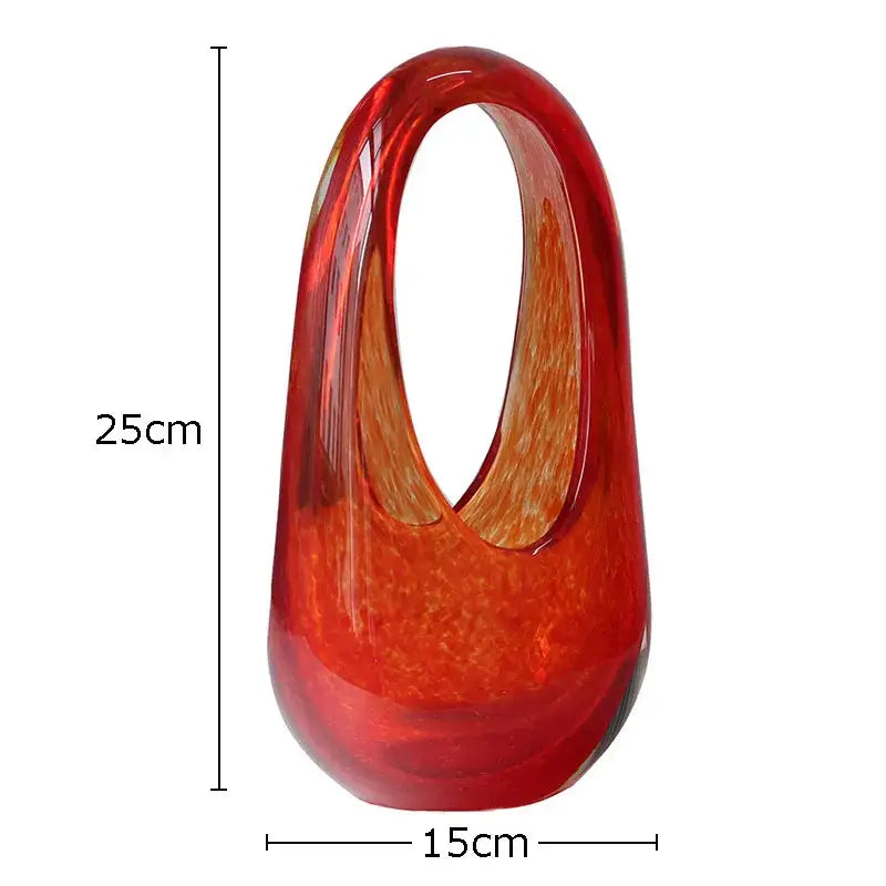 A translucent red decorbites glass vase with a smooth glossy finish and oval handle for home decoration