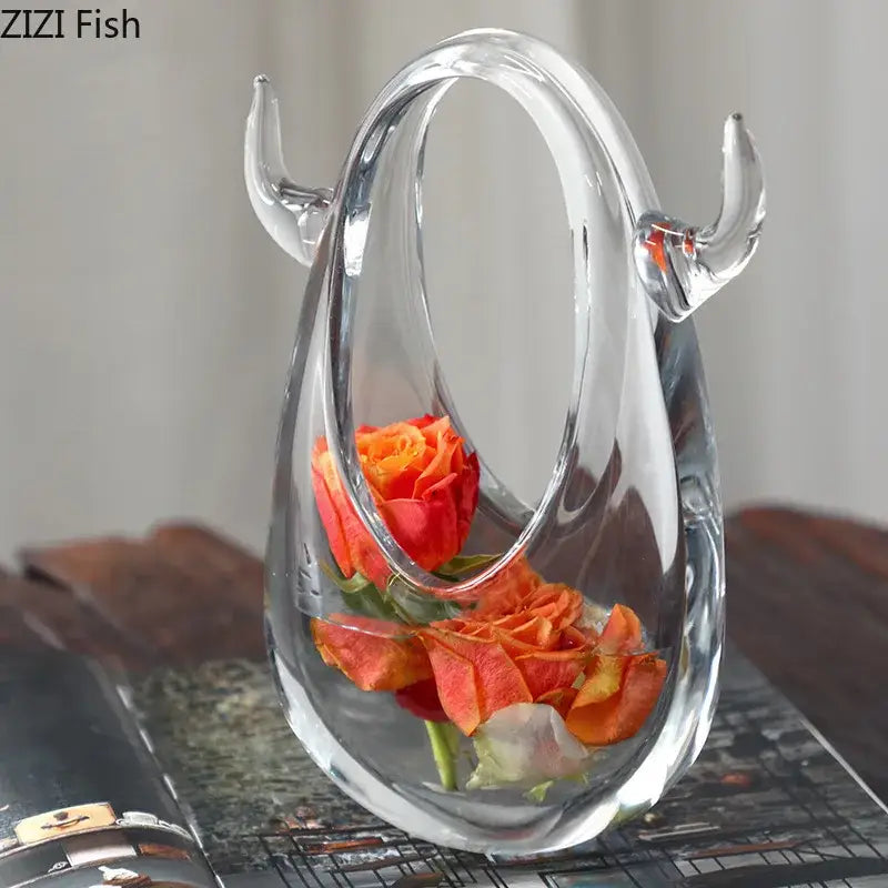 Clear glass decorbites glass vase terrarium with curved horns and oval opening holding orange roses for decoration
