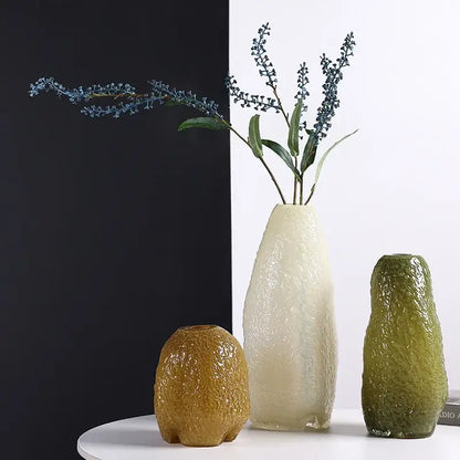 Cream-colored decorbites glass vase with irregular patterns and textured rippling surface for home decor and flower arrangement
