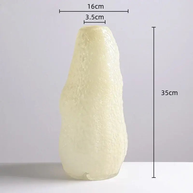 A translucent pale yellow decorbites glass vase with textured organic surface and tapered shape for home decor