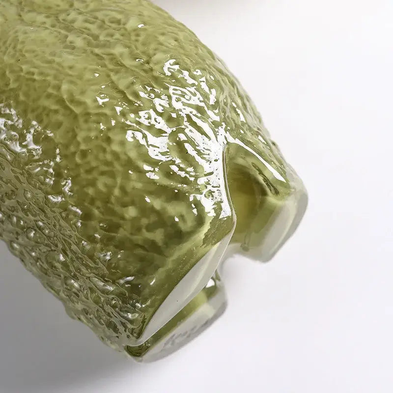 DecorBites glass vase in translucent olive green with a textured hammered surface for flower arrangement and decor