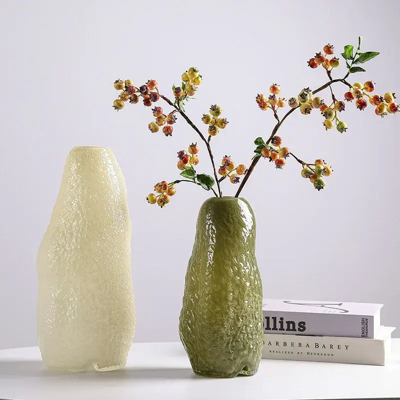 Green textured ceramic decorbites glass vase with irregular patterns holding orange and yellow berry branches for decor