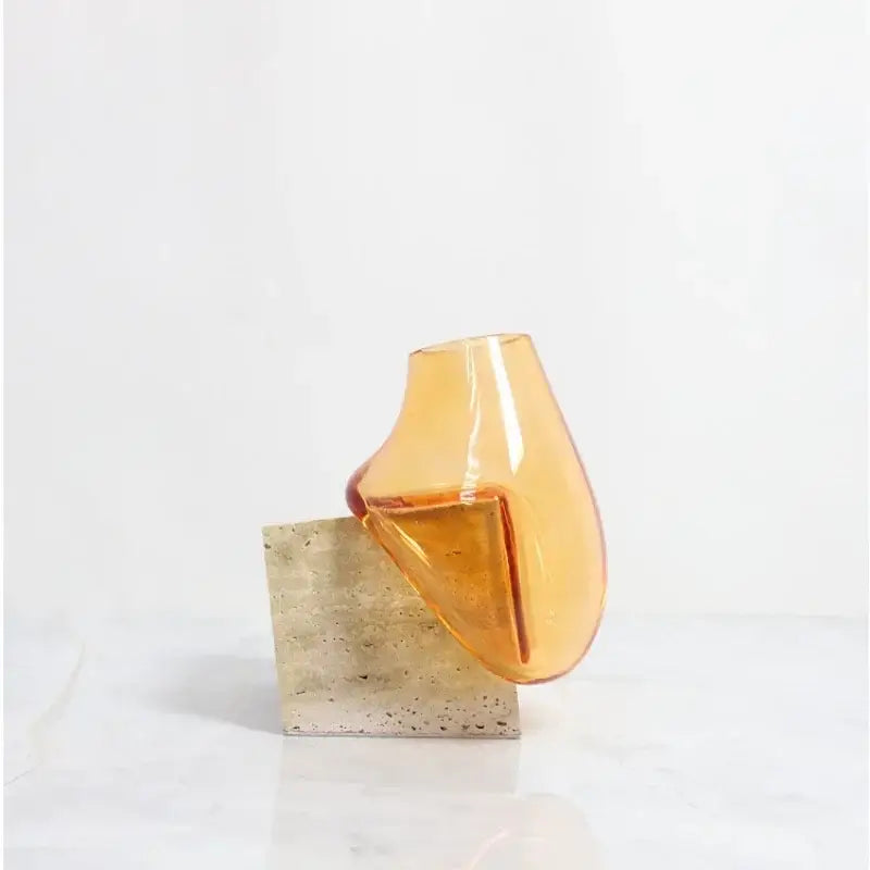 DecorBites glass vase with translucent amber glass, smooth organic curve, and marble base for elegant home décor