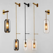 Modern minimalist decorbites glass wall art light with brass and black metal arms and clear smoky gray glass shades