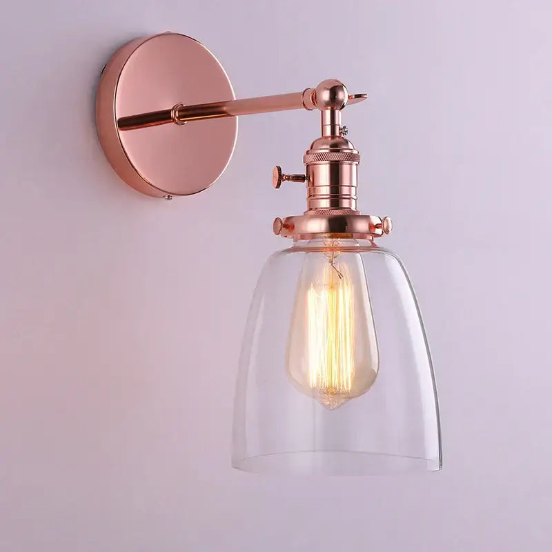 Rose gold vintage-style glass wall lamp with clear glass shade and exposed Edison bulb for living room lighting