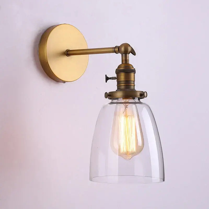 DecorBites™ brass-finished glass wall lamp with clear shade and exposed filament bulb for living room lighting