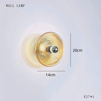 Gold-toned DecorBites glass wall lamp with concentric circular ridges and dimmable LED for living room lighting