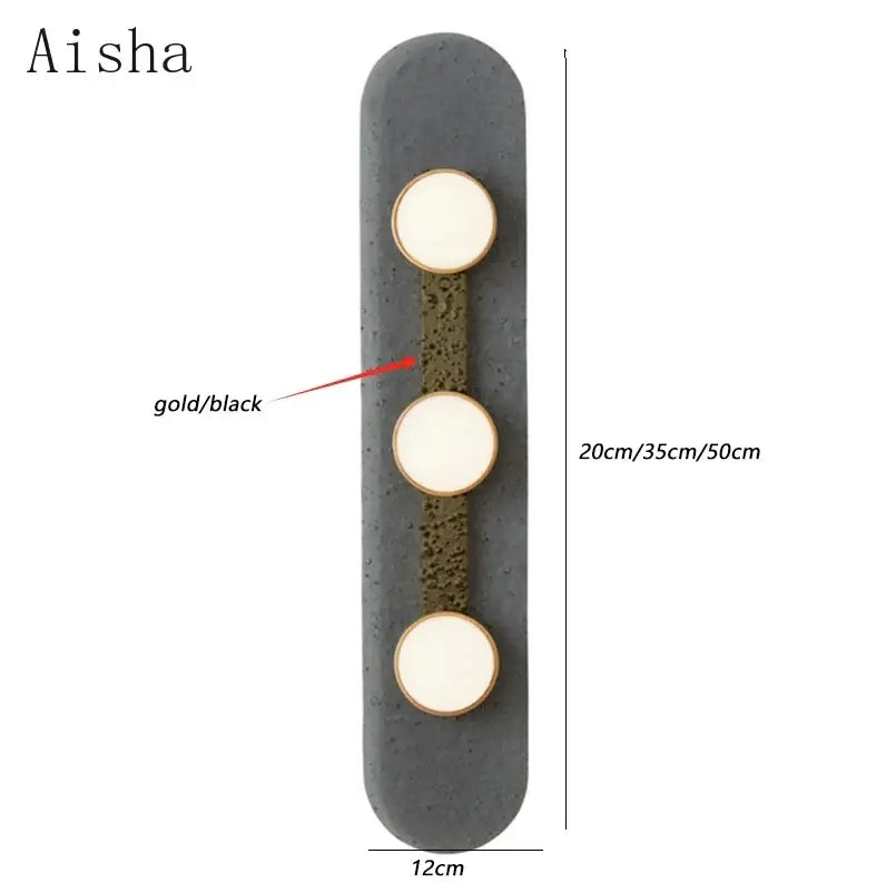 Aisha brand decorbites glass wall lamp with three gold-rimmed lights on black concrete textured panel
