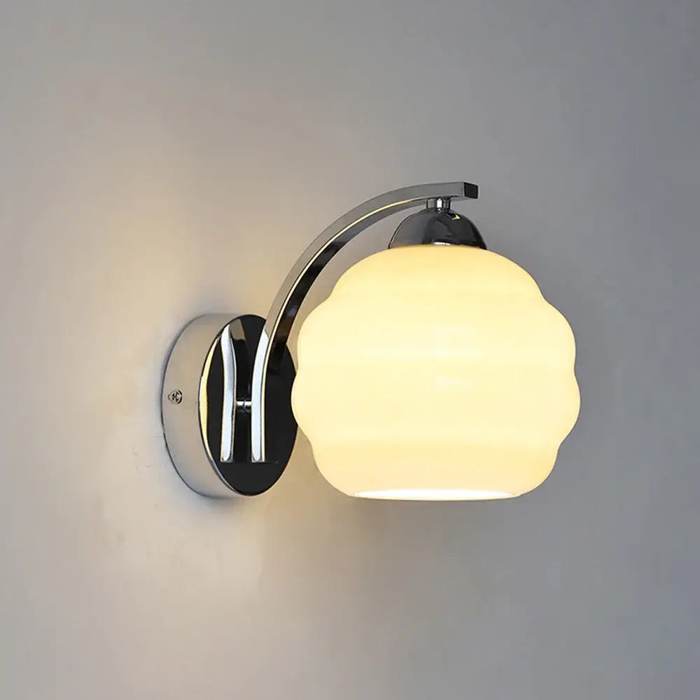 Chrome-finished decorbites glass wall lamp with frosted glass shade emitting warm light for modern aisle and bedroom use
