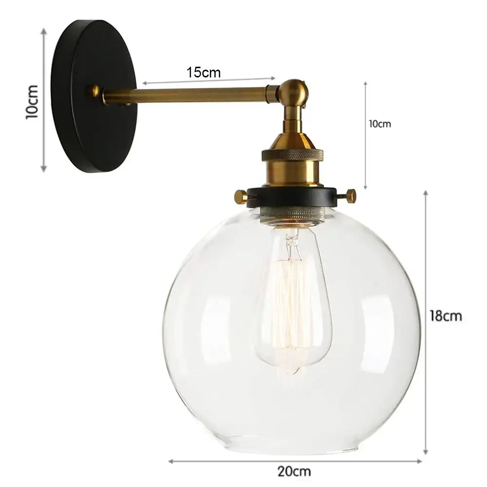DecorBites glass wall lamp with brass finish metal arm and clear glass globe housing exposed Edison bulb for indoor use