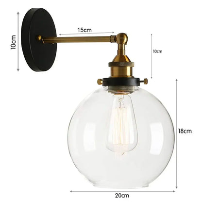 DecorBites glass wall lamp with brass finish metal arm and clear glass globe housing exposed Edison bulb for indoor use