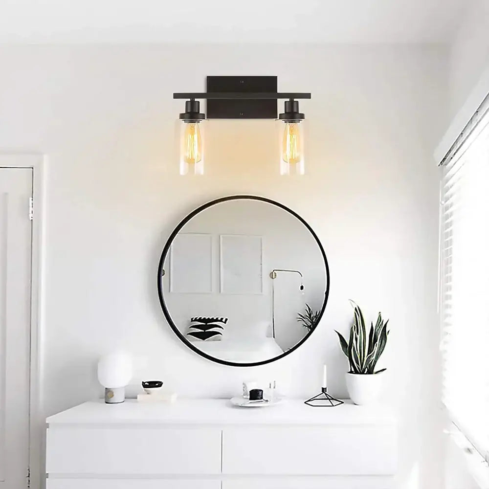 Black metal decorbites glass wall lamp with two exposed filament bulbs in clear glass shades for modern indoor lighting