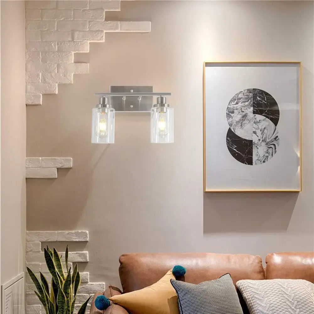 Modern silver-finished decorbites glass wall lamp with two clear glass shades and exposed filament bulbs for indoor lighting