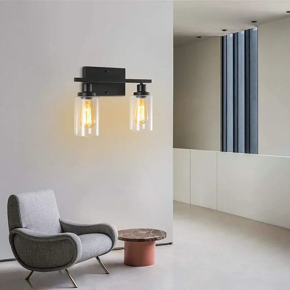 Black metal DecorBites glass wall lamp with two clear glass shades and vintage filament bulbs for modern indoor lighting