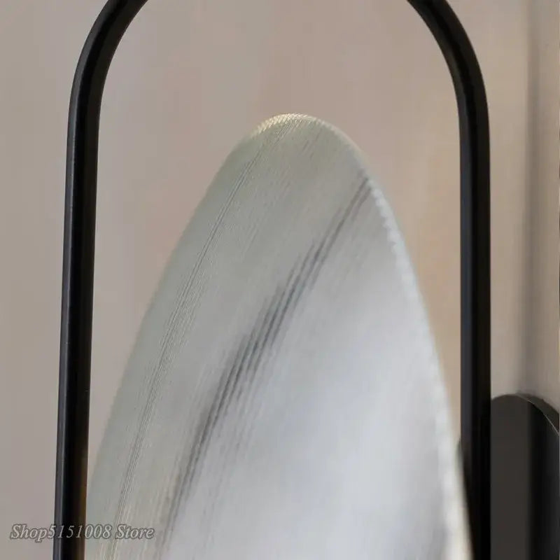 Decorbites glass wall lamp featuring a sleek black metal frame and frosted glass with subtle gray veining for modern decor