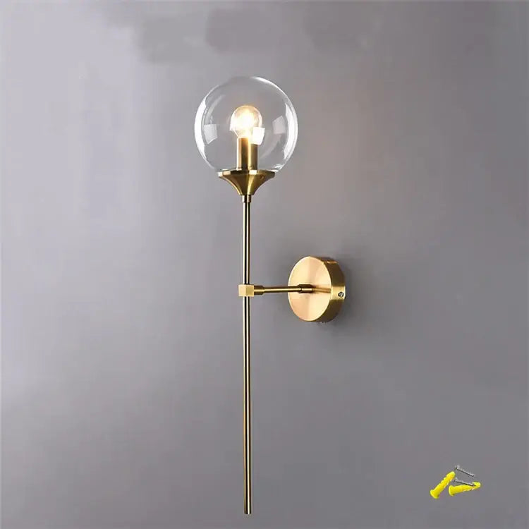 Brass-finished decorbites glass wall lamp with clear glass globe and slender stem for home and bedroom lighting