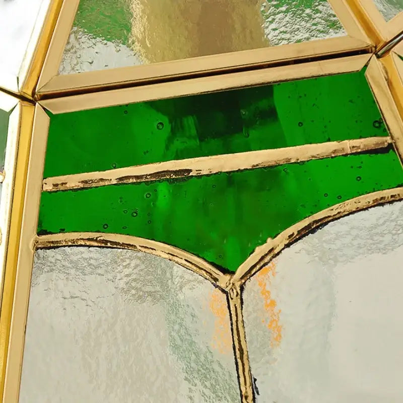 DecorBites glass wall lamp with vintage stained glass panel in green and frosted white framed by gold-toned lead lines