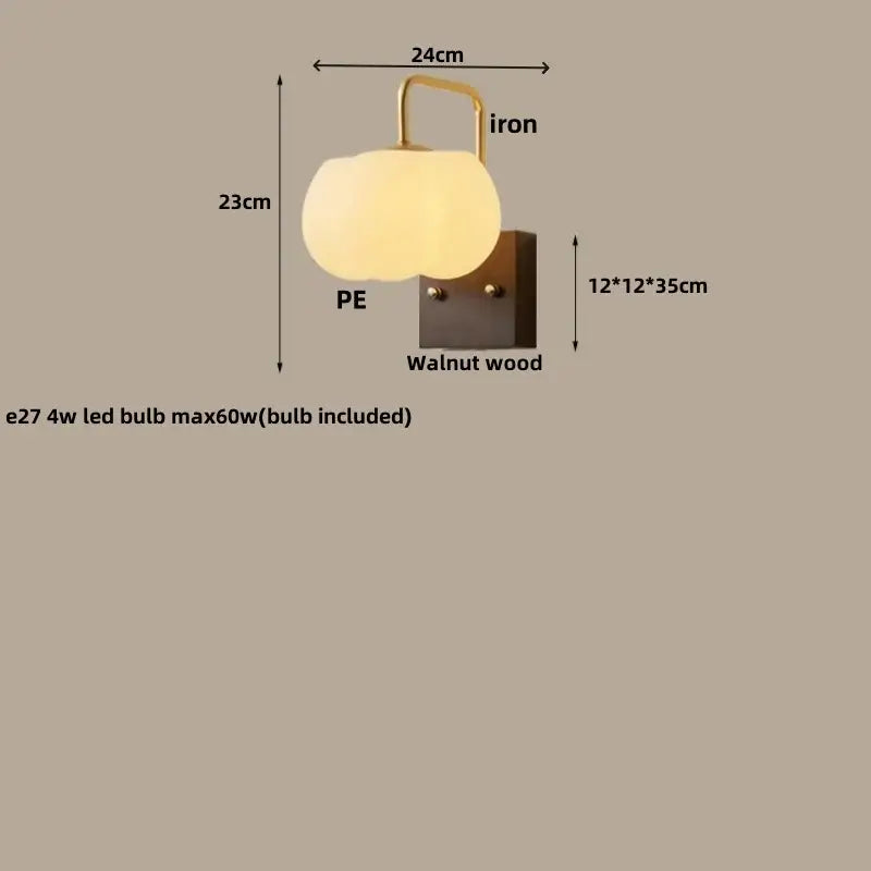 A warm pumpkin-shaped decorbites glass wall light fixture with translucent pe diffuser and walnut wood base