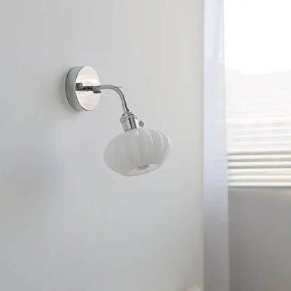 White ceramic wall light fixture with fluted shell-like shade and chrome metal arm by DecorBites™ with pull chain switch