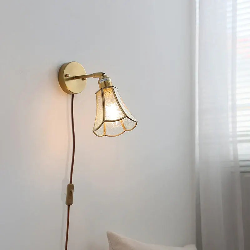 Gold-toned decorbites glass wall light sconce with textured glass shade and circular base for modern nordic lighting