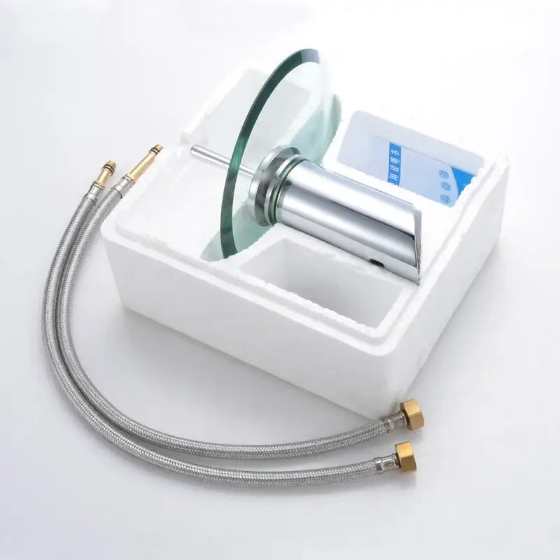 Modern chrome-finished DecorBites basin sink faucet with a sleek curved glass waterfall spout and two flexible metal hoses