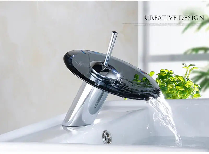 Modern chrome-finished decorbites™ basin sink faucet with sleek transparent black glass waterfall feature
