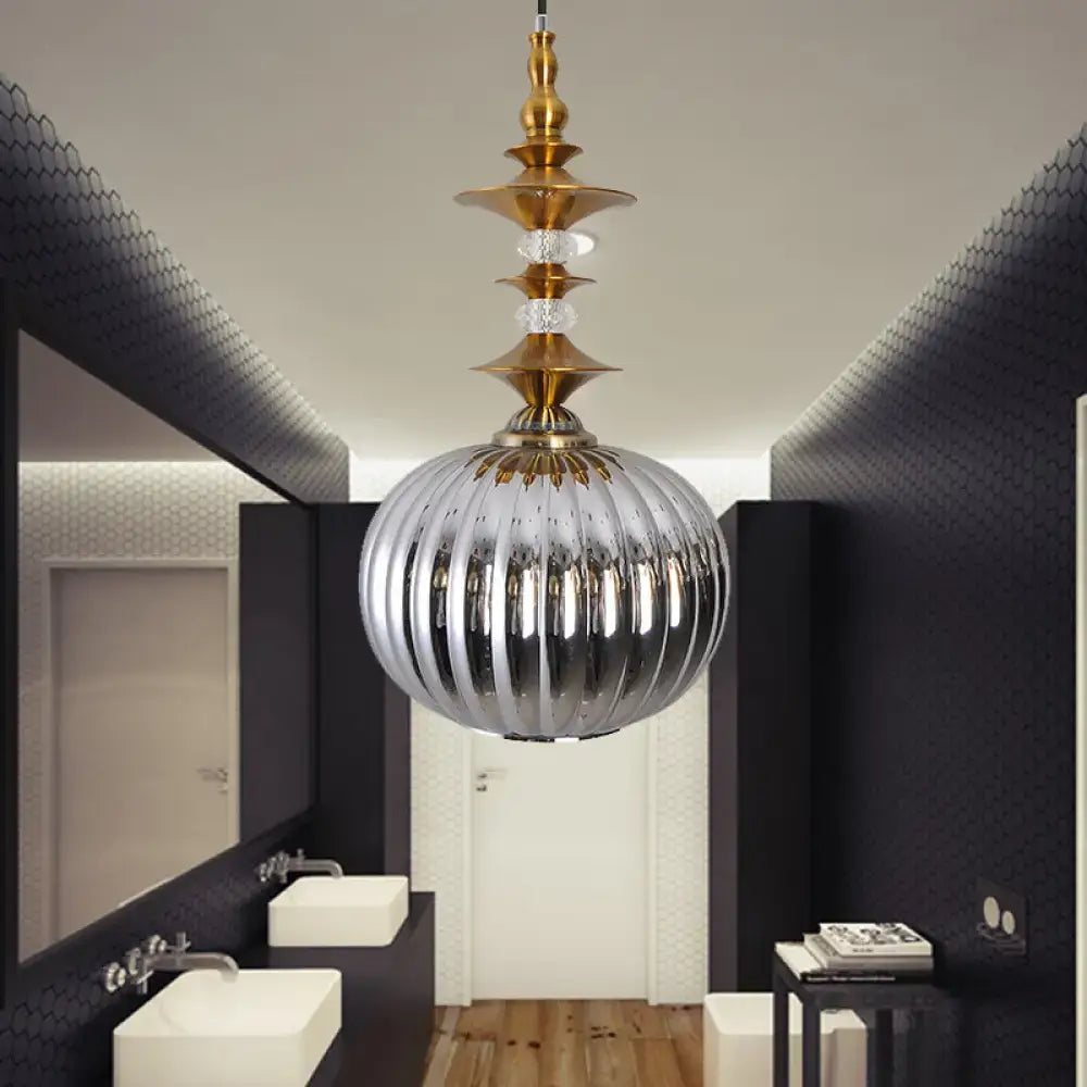 A sleek ribbed silver glass pendant light with gold metal and crystal accents for dining room in chrome copper gold finish