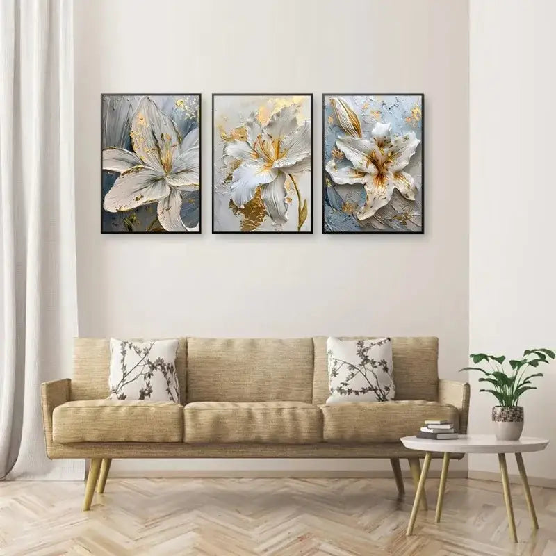 Three framed decorbites gold and white floral 3d white flower canvas wall art above beige sofa