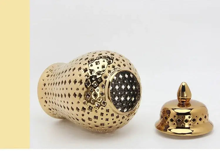 DecorBites gold ceramic carved temple jar with intricate geometric cutouts and matching lid for elegant home decor