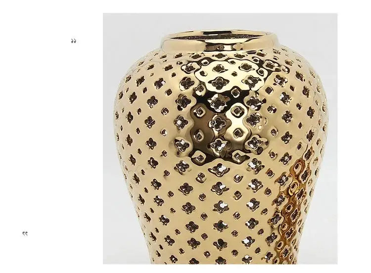 DecorBites™ gold ceramic carved temple jar with intricate quatrefoil patterns and glossy finish for home decor