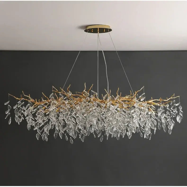 Elegant gold crystal led chandelier with cascading clear crystal leaves suspended from a circular ceiling mount
