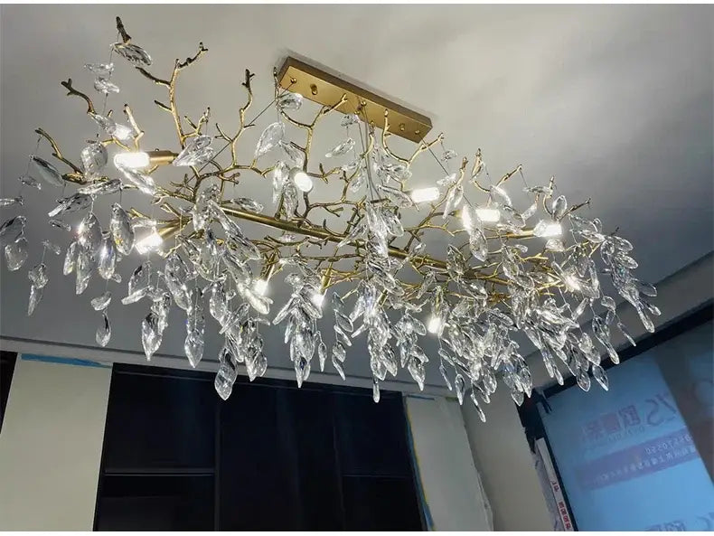 Decorbites gold crystal led chandelier featuring a golden branch design with clear leaf-shaped crystal droplets for home lighting