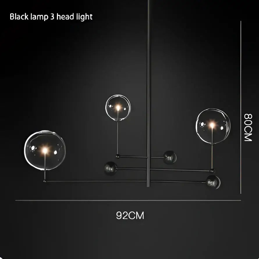 Black metal chandelier featuring three spherical gold glass bubble lights ideal for dining room decor