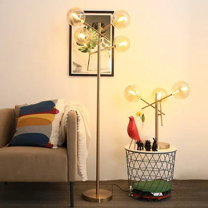 Modern brass-finished floor lamp with gold glass bubble bulbs in a branching design for elegant lighting