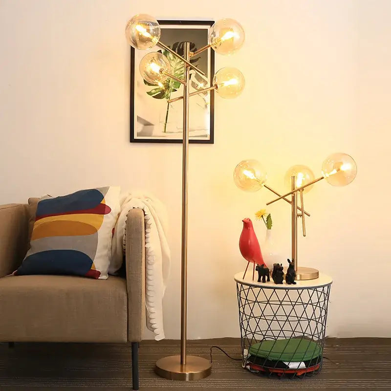 Modern brass-finished floor lamp with gold glass bubble bulbs in a branching design for elegant lighting