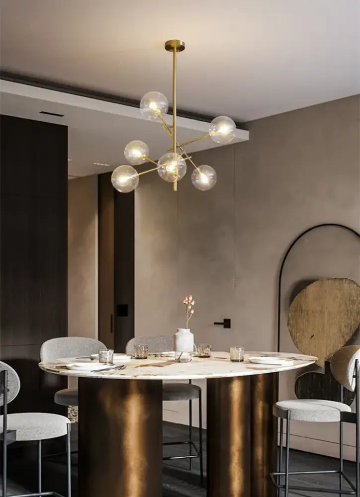 DecorBites™ gold glass bubble chandelier with gold-toned central rod and clear glass globe bulbs for dining room
