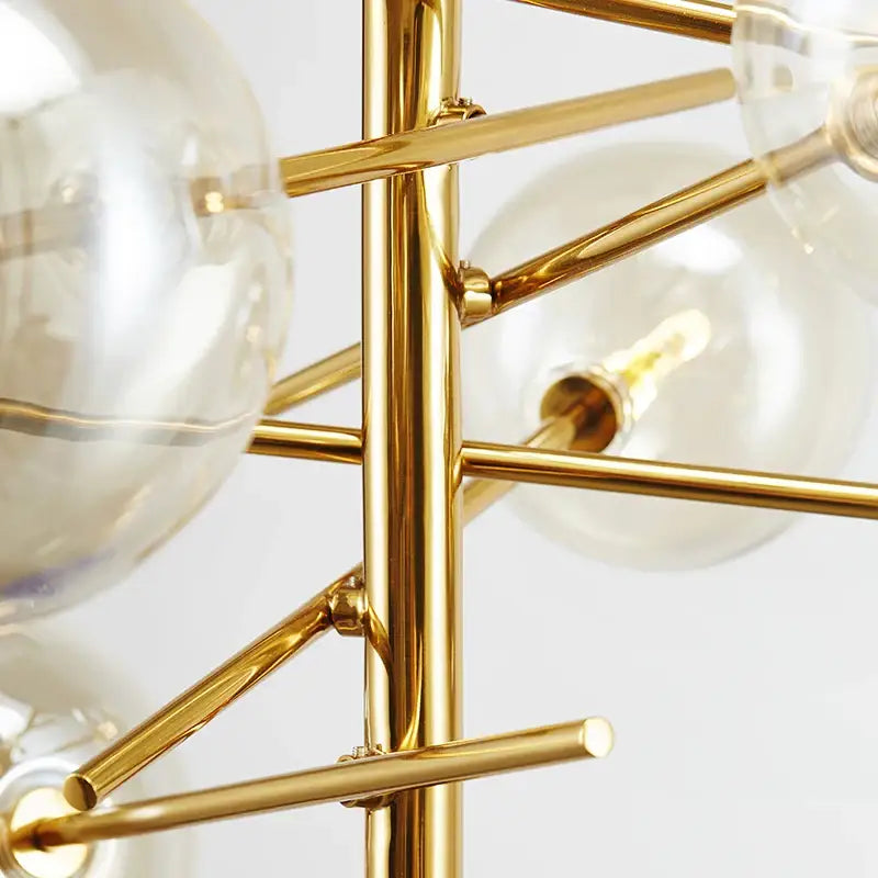 Gold-toned metal DecorBites gold glass bubble chandelier with clear glass globe bulbs for dining room lighting