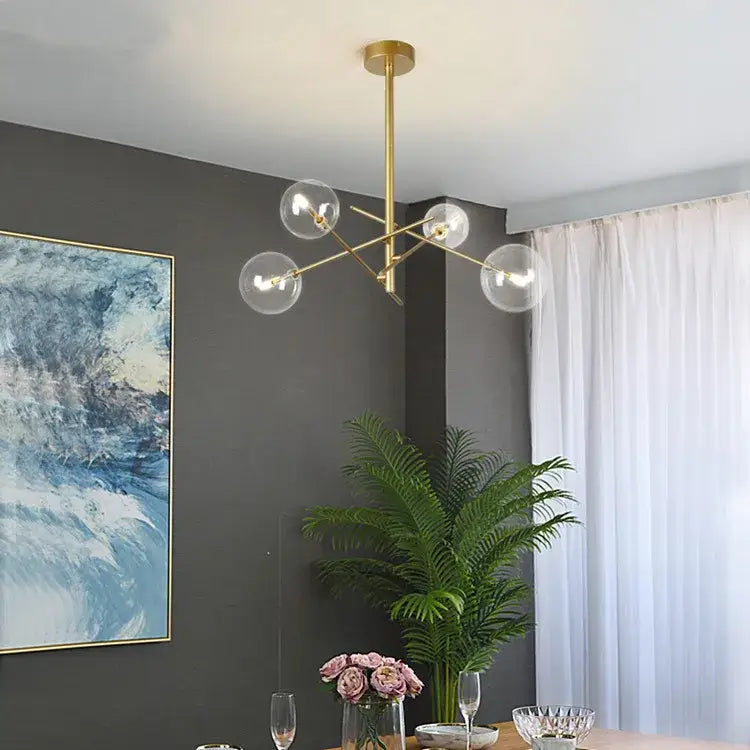 Gold-toned DecorBites gold glass bubble chandelier with clear glass globe bulbs for dining room lighting