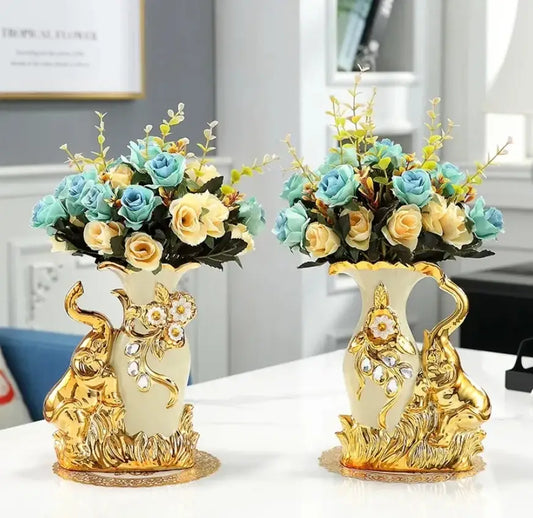 Elegant cream ceramic glass vase with gold glass elephant figurines and blue yellow rose bouquets by decorbites