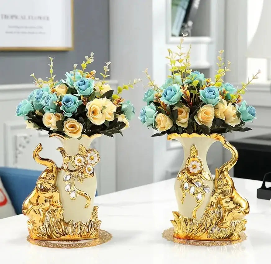 Elegant cream ceramic glass vase with gold glass elephant figurines and blue yellow rose bouquets by decorbites