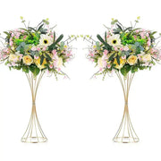 Elegant gold-toned iron flower vases with wireframe pedestal stands holding artificial soft pink yellow and white flowers