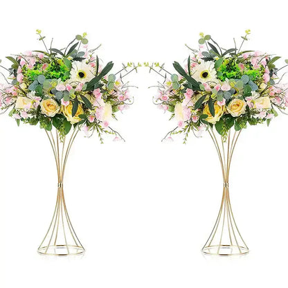Elegant gold-toned iron flower vases with wireframe pedestal stands holding artificial soft pink yellow and white flowers