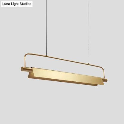 A sleek decorbites™ gold led island light fixture with brushed gold finish and minimalist metallic colonial design for restaurants